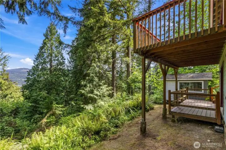 Multi-level decking and exterior access create functional outdoor spaces for recreation and entertaining.