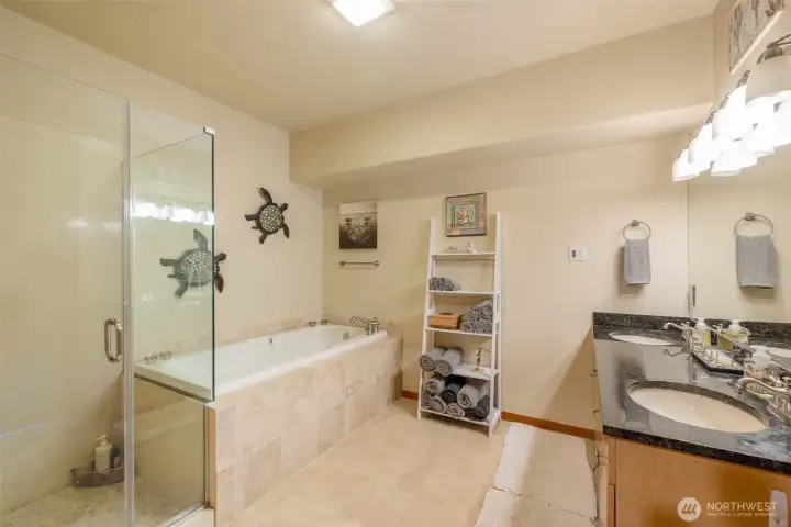 Primary bath with 2 sinks, soaking tub, shower and heated tile floors.