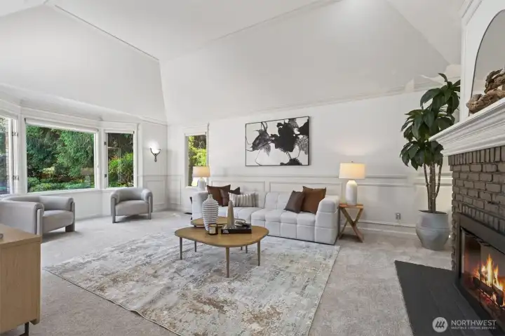 Spacious multipurpose room filled with natural light and a beautiful fireplace that anchors the main gathering space.