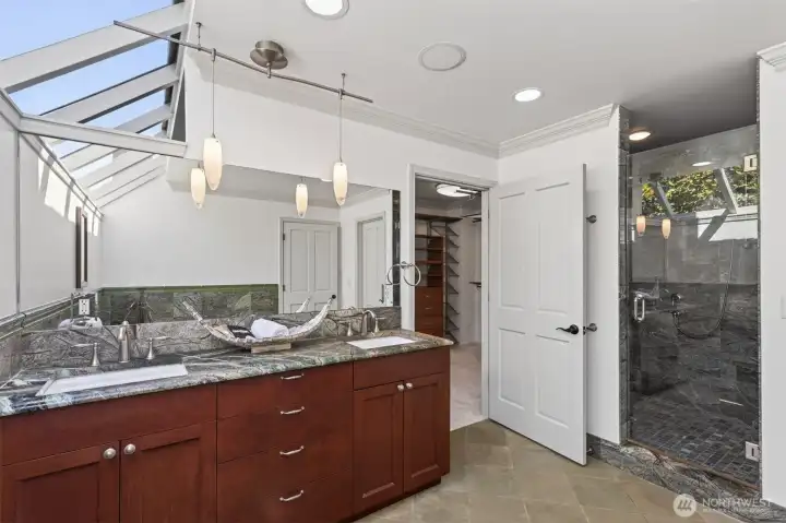Luxurious finishes create a relaxing escape.Off the primary bath is the walk-in closet.