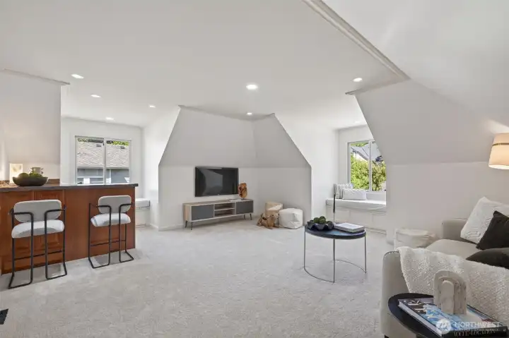 Expansive media room with built-in bar and fridge for entertainment.