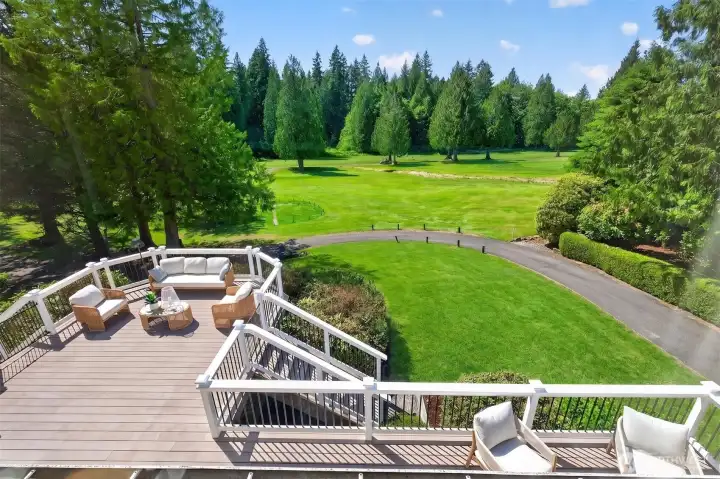 Enjoy outdoor entertaining on the expansive deck that overlooks the golf course, 2nd fairways, and lush greenery.