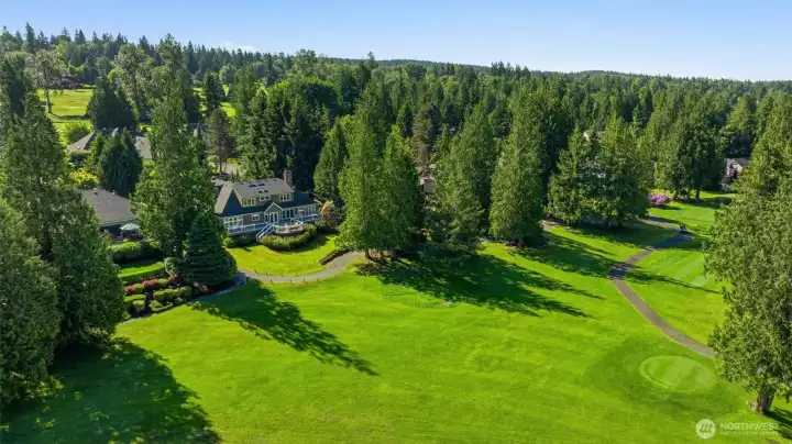 Aerial of the back of the home overlooking the golf course.