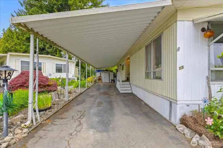 Deep covered carport providing ample parking space.