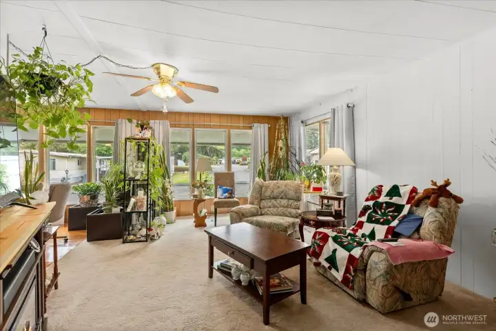Spacious, light-filled living room featuring an abundance of windows.