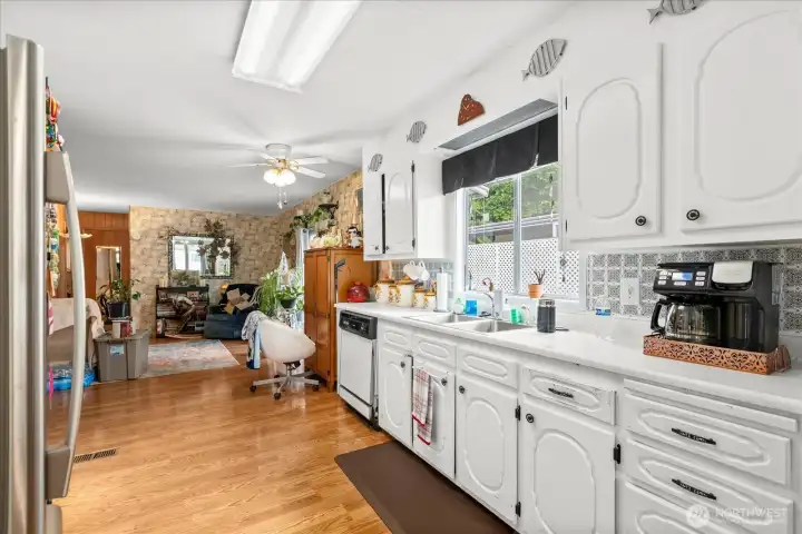 Galley-style kitchen featuring an open-concept layout that flows seamlessly into the family and dining rooms.