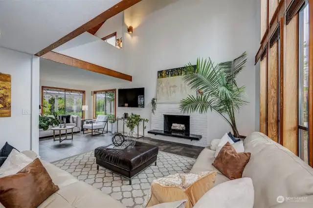 Large, light-filled living room with 25' ceiling.  Wood burning fireplace is plumbed for easy gas conversion.