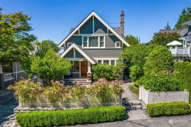 This classic craftsman is perched on the top of Queen Anne Hill, with amazing street appeal- the white picket fence is lined with roses, and the professionally landscaped yard has a variety of flowers that bloom in succession.