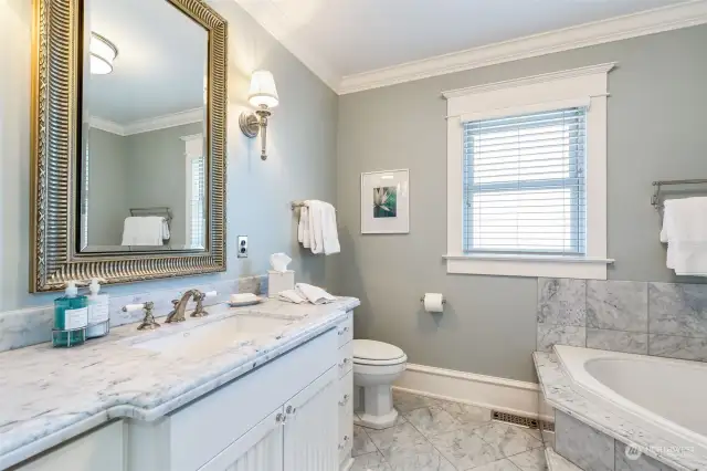 The primary bath is beautiful and practical with details like outlets in the drawer and a heated vanity mirror so that it won't fog when the room is steamy!