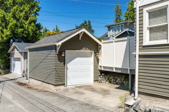 The garage with access off the alley.  There is plenty of space in that driveway to park a second car.  This area is also monitored with cameras as part of the security system.