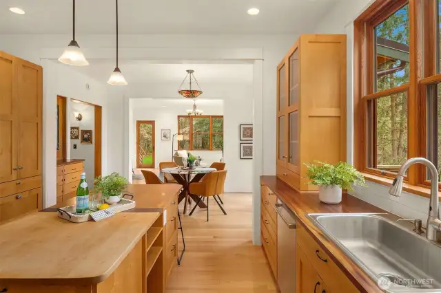 Kitchen open to dining with living room on the other side.