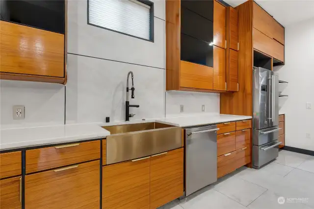 Kitchen includes teak cabinets with brass hardware and beautiful copper apron front sink.