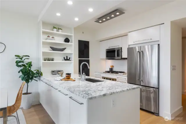 Carrara marble countertops. Stainless steel appliances. Beautiful backsplash.