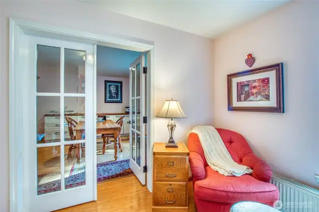 Another lower room is set up as a studio and office with French doors dividing the two sections. This is the office area.