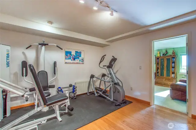 This is one end of the lower floor bonus room with equipement to keep you in shape. Hobby room is in the door to the right