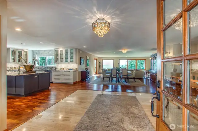 Living and dining area straight ahead with the large kitchen to the left. Primary, library/den and half guest bath are to the right