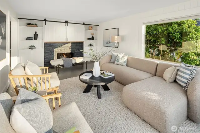 Living room on main with fireplace with view windows at your back.