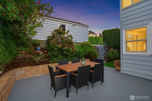 Relaxing space on patio with garage in back on alley.