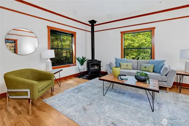 So much natural light cascades in from lovely windows, looking out into the green-scape, making you feel like your up in the treetops. Notice the wood burning stove which heats the whole upstairs on a winters day.