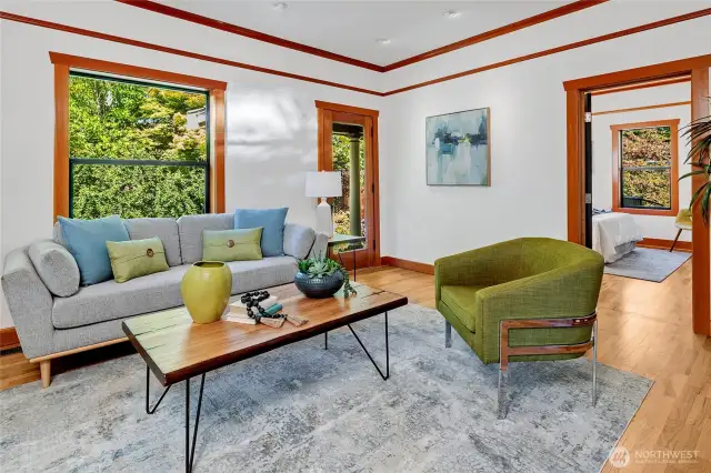 The original porch lies on the North side of the home and when open invites a wonderful breeze to flow throughout, all the while, enjoying the gardens and trees. The custom lighting also allows for featuring your desired wall art and paintings.