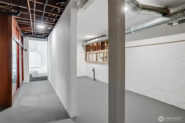 The large vintage storage closet resides on the left, while on the right is a room full of opportunity. Plumbed for a 3/4 bath, kitchenette, studio work space or shop, the possibilities are only limited by your creativity.  Also, additonal storage if desired.