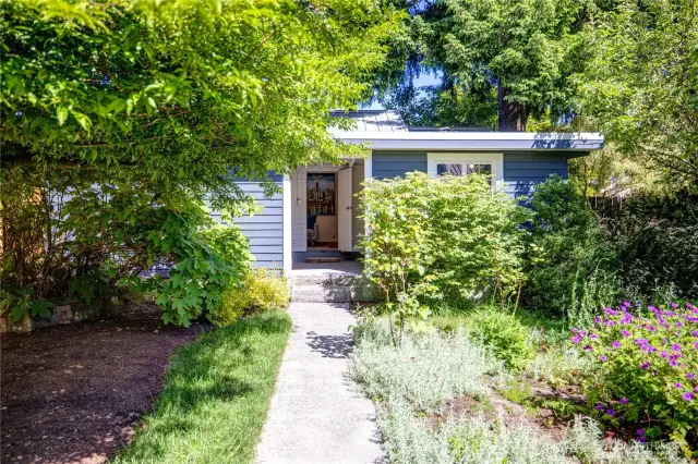 Across from the main house is the garage and DADU/Studio cottage with separate laundry and storage.