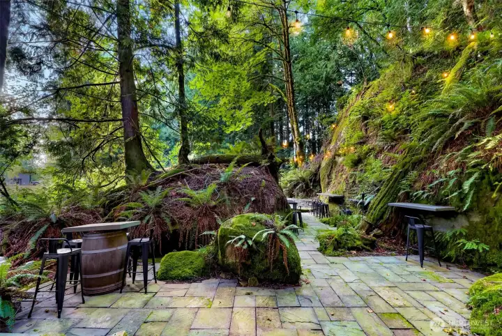 Monolith Chuckanut sandstone "Grotto" with tables and chairs, lighting and fire pits