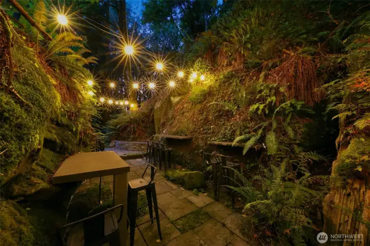 Monolith Chuckanut sandstone "Grotto" with tables and chairs, lighting and fire pits