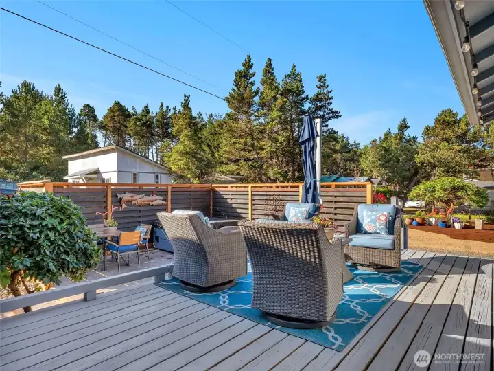 Secluded outdoor space with patio, deck, and hot tub.