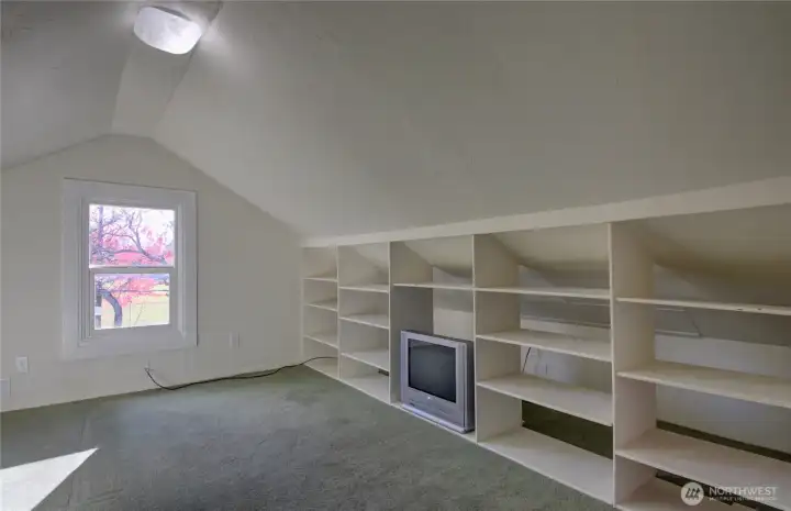 Upstairs bedroom with built in bookshelves.