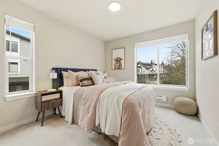 Third bedroom with bright windows and flexible space for work-from-home or hobbies