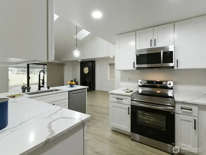 White Quartz counter tops.  All Stainless appliances new.  New custom cabinets w/ handles and Recessed lighting too.