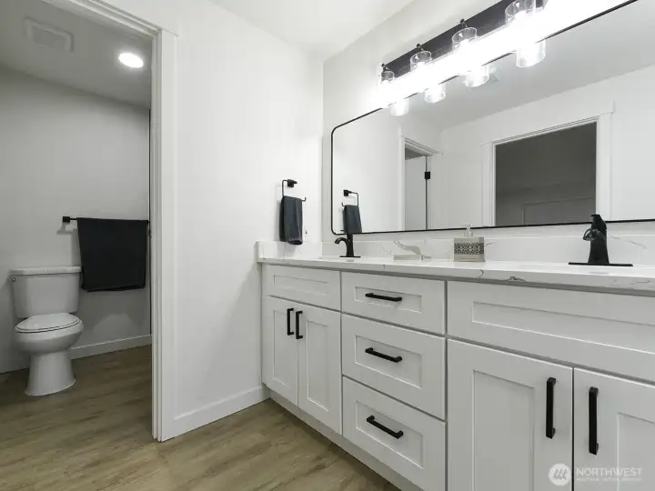 Primary bath. Shower.  New cabinets with two sinks and Quartz counter tops. Full length mirrow. Designer lighting.