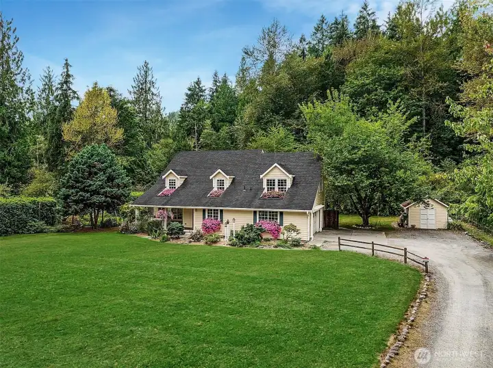 Classic Farmhouse Retreat on a private and serene 1.07 Acre lot.