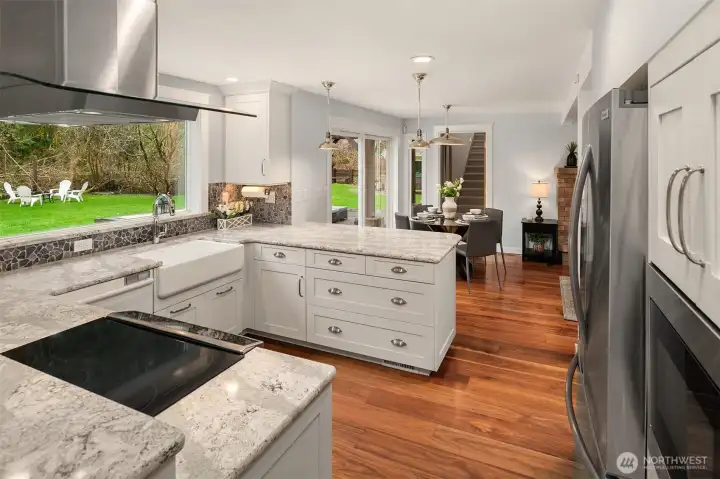 Remodeled kitchen with gorgeous highly detailed slab granite, stainless appliances and huge kitchen widow overlooking nature.