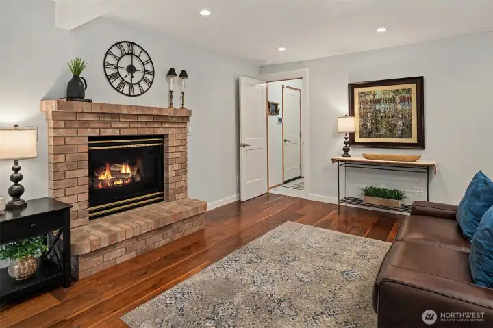 Family room with raised-hearth propane fireplace.