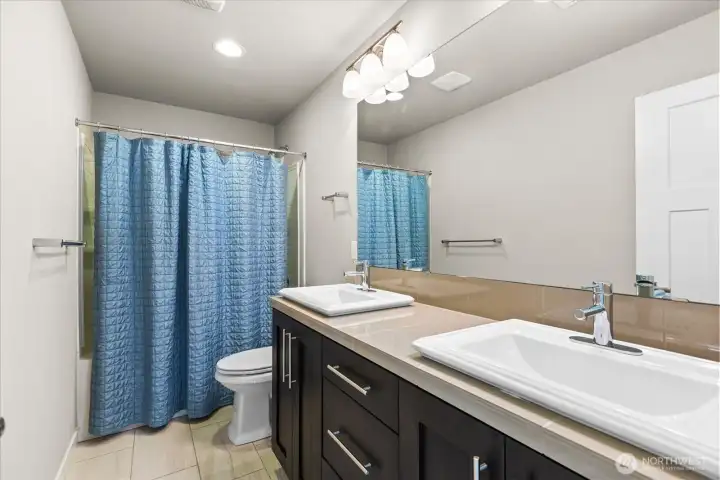 Upper level main bath with tiled flooring