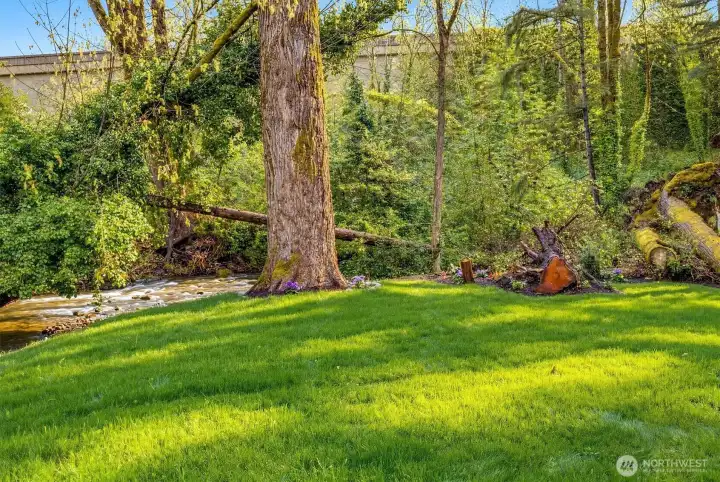 Breathtaking oasis backs to a serene, babbling creek that makes this outdoor space truly one of a kind.