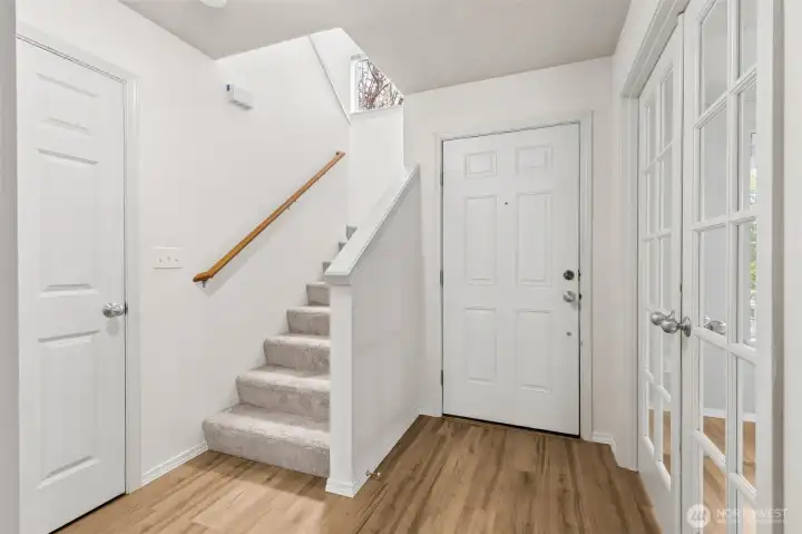 Nearly new flooring throughout - vinyl plank downstairs. White doors and trim.