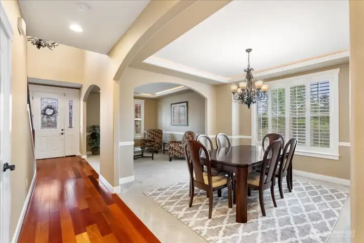 Welcome into the stunning entry showcasing gorgeous Brazilian cherry hardwood floors, where beautifully crafted columns and graceful arches create a truly artistic design.
