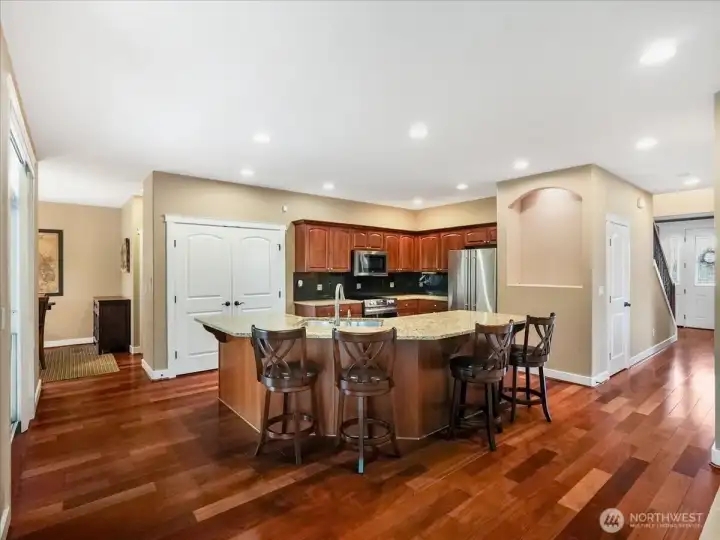 Okay, now just look at that flooring, the gorgeous granite island and the double door pantry.  So pretty!