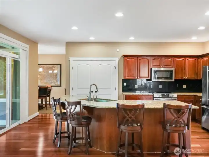 More kitchen space with a sliding door out to the beautiful covered patio.
