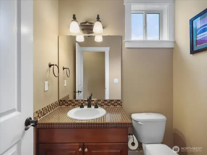 A cute very private 1/2 bath just around the corner from the kitchen area.