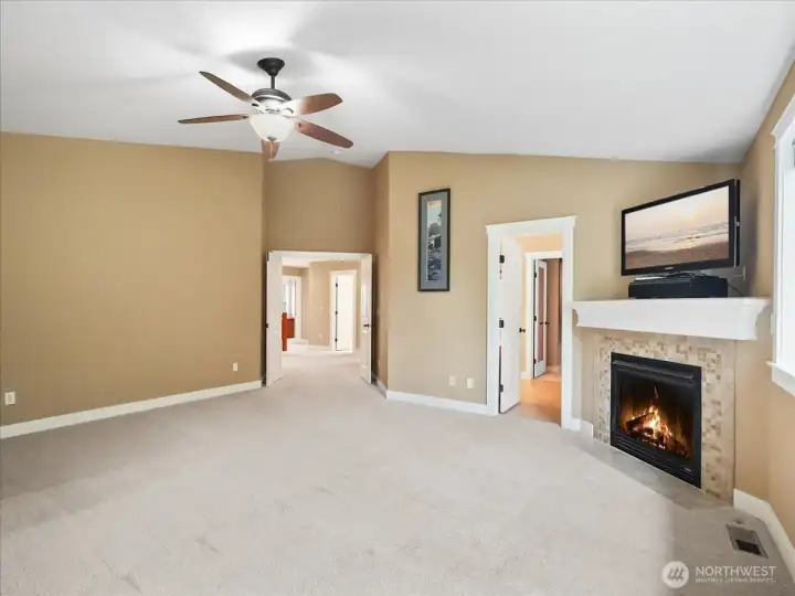 Such a great primary bedroom with that cozy fireplace!