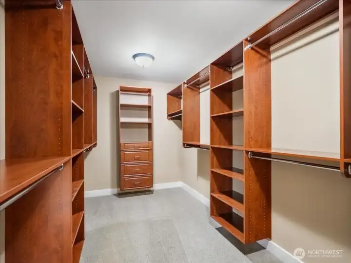 Oh my gosh, look at all of those built-ins in the primary walk-in closet.
