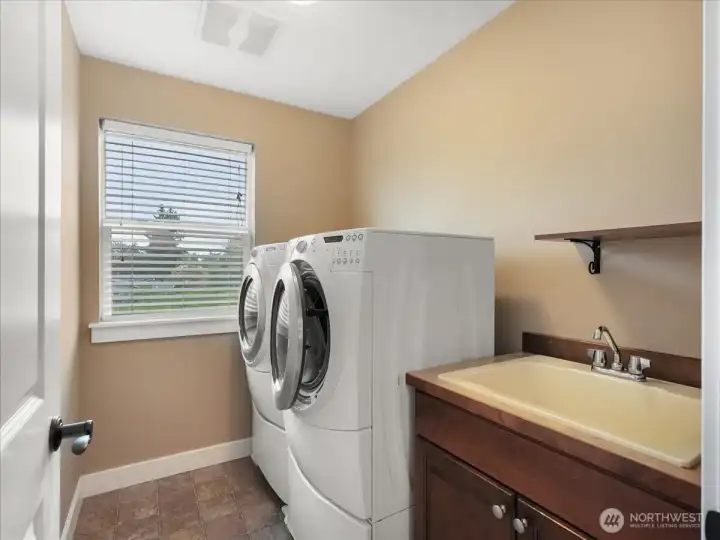 Upstairs laundry room with laundry sink.  Washer and dryer stay with the home.
