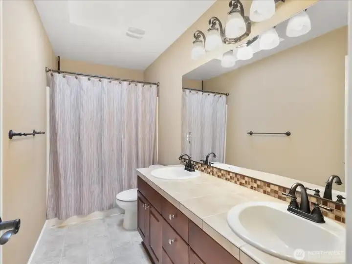 Upstairs main bath with double sinks.