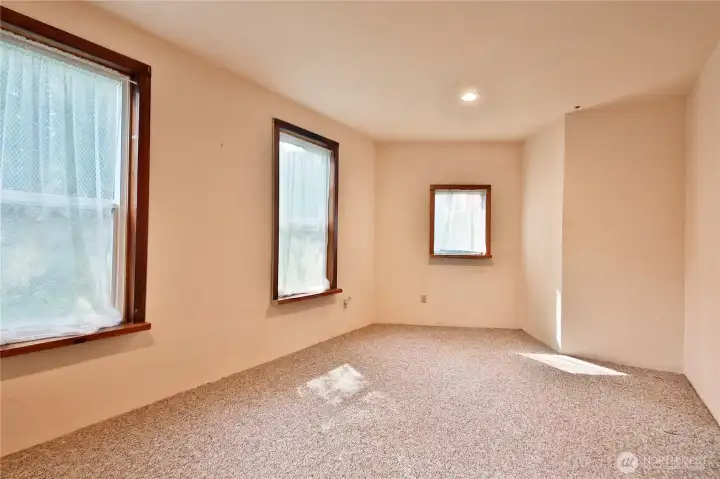 The large bedroom on the lower level of the home looks out to the surrounding landscaping.