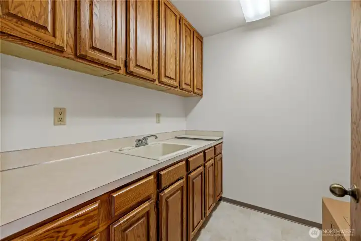 Again, the cabinets are in great condition in this laundry room with new flooring