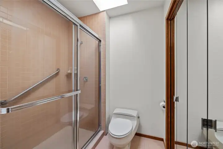 Master shower area with linen storage to the right